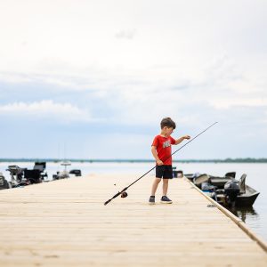 Young boy fishing off the dock