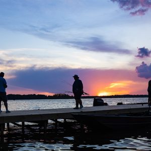 Sunset on Reelfoot lake with people standing on a dock