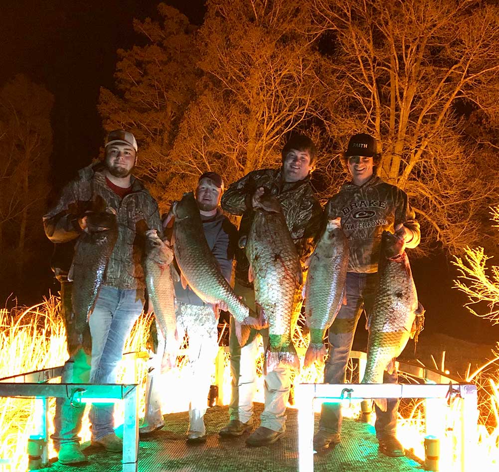 group of men with fish they caught